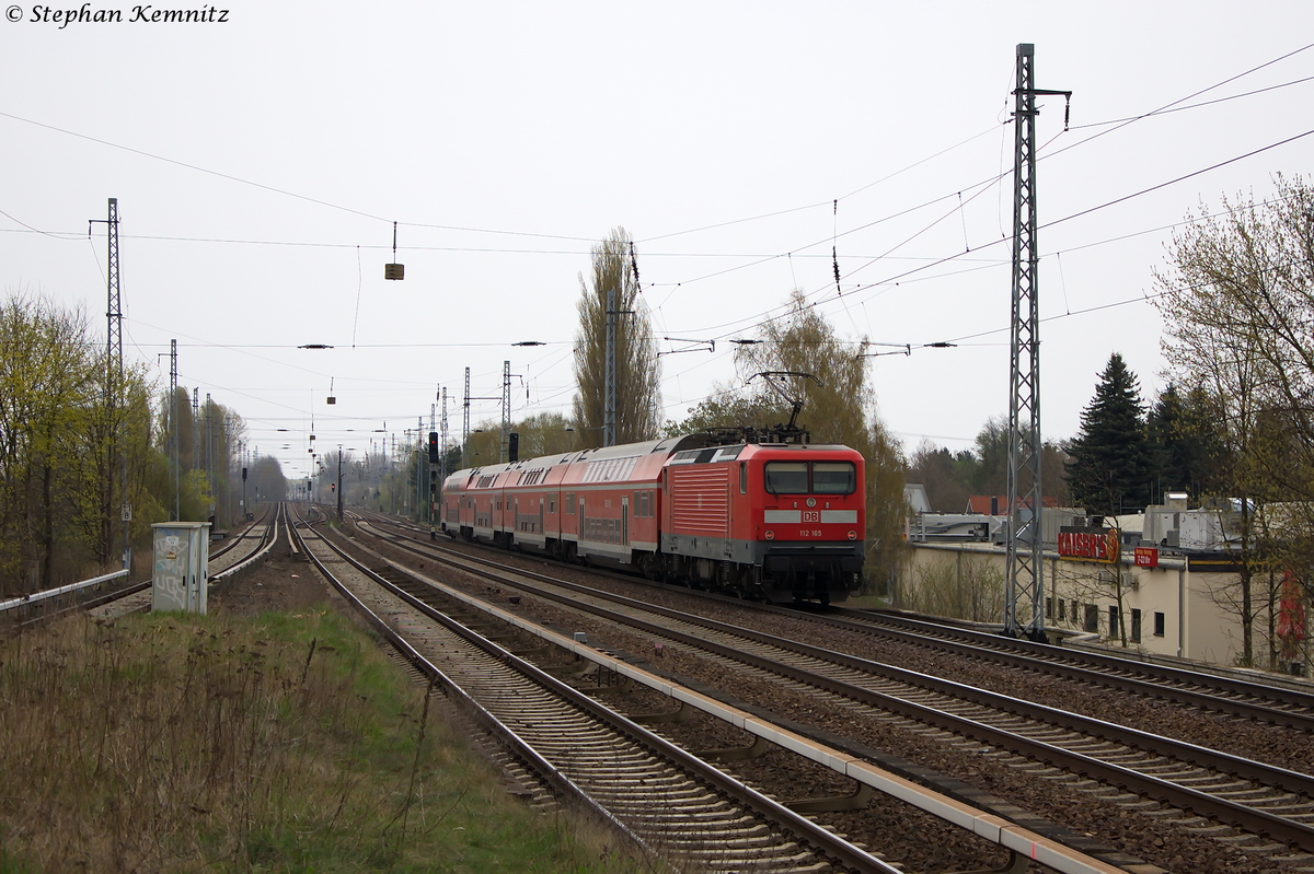 112 165 mit dem RE3 (RE 18312) von Elsterwerda nach Stralsund Hbf, bei der Durchfahrt in Berlin-Karow. 04.04.2014